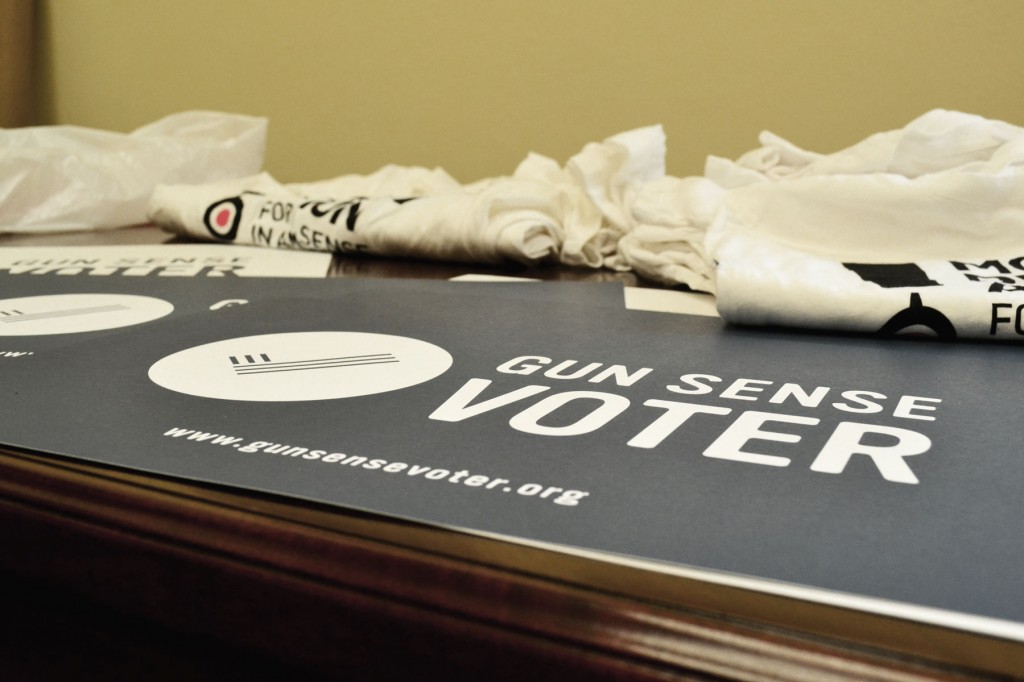 Posters bearing Everytown's "Gun Sense Voter" slogan sit on a table at a May 7 Moms Demand Action press conference on Capitol Hill in Washington.